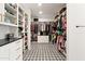 Spacious walk-in closet with custom shelving, drawers, and tile flooring provides ample storage and organization at 1013 W Ardmore Rd, Phoenix, AZ 85041