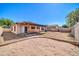 A full view of the backyard that features a covered patio, sand box, and block fence at 10541 W Foothill Dr, Peoria, AZ 85383