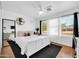 Bedroom with a ceiling fan, hardwood floors, and a view to the backyard at 10541 W Foothill Dr, Peoria, AZ 85383