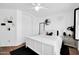Bright bedroom featuring white walls, hardwood floors, and modern ceiling fan at 10541 W Foothill Dr, Peoria, AZ 85383