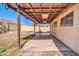 View of the covered patio with string lights, ceiling fan, and concrete flooring at 10541 W Foothill Dr, Peoria, AZ 85383