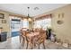 Bright dining area with tile floors, a table set for a meal, and a sliding glass door to the backyard at 10541 W Foothill Dr, Peoria, AZ 85383