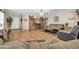 Cozy living room featuring a large entertainment center, comfortable seating, and laminate wood flooring at 10541 W Foothill Dr, Peoria, AZ 85383
