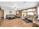 Spacious living room with laminate floors, plush seating, a ceiling fan, and an open floor plan at 10541 W Foothill Dr, Peoria, AZ 85383