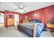 Main bedroom featuring red walls, neutral carpet, ceiling fan and generous space at 10541 W Foothill Dr, Peoria, AZ 85383