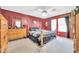 Main bedroom with red walls, carpet flooring, a ceiling fan and well-placed dresser at 10541 W Foothill Dr, Peoria, AZ 85383