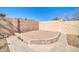 Enclosed sand box surrounded by pavers and a tall block fence, offering a fun outdoor feature at 10541 W Foothill Dr, Peoria, AZ 85383