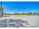 Well-maintained tennis courts with lighting, surrounded by fencing and trees at 10541 W Foothill Dr, Peoria, AZ 85383