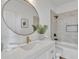 Bathroom featuring round mirror and marble backsplash at 1071 N Danyell Dr, Chandler, AZ 85225