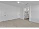 A bright primary bedroom offers a neutral color scheme, ceiling fan, and an ensuite bathroom at 1071 N Danyell Dr, Chandler, AZ 85225