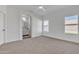 Spacious carpeted bedroom with neutral tones, ceiling fan, and ensuite bathroom at 1071 N Danyell Dr, Chandler, AZ 85225