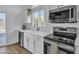 Well-lit kitchen featuring sleek appliances, white cabinetry, and modern finishes at 1071 N Danyell Dr, Chandler, AZ 85225