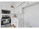 Modern kitchen features stainless steel appliances, white cabinets and tile backsplash at 1071 N Danyell Dr, Chandler, AZ 85225