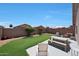 Inviting backyard offering patio furniture, desert landscaping and green lawn at 11207 W Turney Ave, Phoenix, AZ 85037