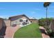 Spacious backyard featuring desert landscaping, grass and patio furniture at 11207 W Turney Ave, Phoenix, AZ 85037