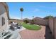 Relaxing backyard featuring desert landscaping, patio furniture, and palm trees at 11207 W Turney Ave, Phoenix, AZ 85037