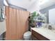 A well-lit bathroom features a vanity with sink, toilet, and shower with curtain at 11207 W Turney Ave, Phoenix, AZ 85037