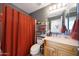 Cozy bathroom with shower, vanity, and warm lighting at 11207 W Turney Ave, Phoenix, AZ 85037