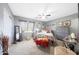 A stylish bedroom features calming colors, a ceiling fan, and plush carpet at 11207 W Turney Ave, Phoenix, AZ 85037