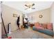 Bedroom featuring ceiling fan, a sofa, desk, and a window with blinds at 11207 W Turney Ave, Phoenix, AZ 85037