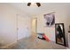 A well-lit bedroom with a ceiling fan, carpet, and closet doors at 11207 W Turney Ave, Phoenix, AZ 85037