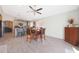 Bright dining area and kitchen featuring a ceiling fan and wood-look flooring at 11207 W Turney Ave, Phoenix, AZ 85037