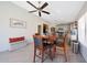 Open dining area flows into the kitchen with a stylish light fixture and tile flooring at 11207 W Turney Ave, Phoenix, AZ 85037