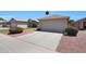 Lovely home exterior with a two car garage, xeriscaping, and desert plants at 11207 W Turney Ave, Phoenix, AZ 85037