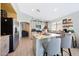 Bright kitchen with island seating, stainless appliances, open floor plan and wood-look floors at 11207 W Turney Ave, Phoenix, AZ 85037
