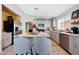 Modern kitchen with island, granite counters, stainless appliances, and wood-look floors at 11207 W Turney Ave, Phoenix, AZ 85037