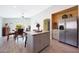 Open concept kitchen with center island, stainless appliances, and wood-look flooring at 11207 W Turney Ave, Phoenix, AZ 85037