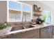Bright kitchen featuring granite countertops, stainless sink, and decorative accents at 11207 W Turney Ave, Phoenix, AZ 85037