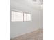 A bright bedroom featuring a window, a ceiling fan, and neutral carpet at 11836 W Rosewood Dr, El Mirage, AZ 85335