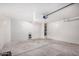 Spacious garage featuring concrete flooring and a door at 11836 W Rosewood Dr, El Mirage, AZ 85335
