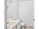Convenient half bathroom with tile flooring, white vanity, and neutral decor at 11836 W Rosewood Dr, El Mirage, AZ 85335