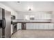 Spacious kitchen with stainless steel appliances, granite countertops, and white cabinetry at 11836 W Rosewood Dr, El Mirage, AZ 85335