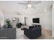 Neutral living room with tile flooring and ceiling fans with comfortable sofas and decor at 11836 W Rosewood Dr, El Mirage, AZ 85335