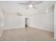 Open-concept living room featuring tile floors and ceiling fans at 11836 W Rosewood Dr, El Mirage, AZ 85335