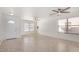 Bright living room with tiled floors, ceiling fans, and large windows offering plenty of natural light at 11836 W Rosewood Dr, El Mirage, AZ 85335
