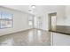 Bright, open living space with neutral tile, large windows, and a breakfast bar at 11836 W Rosewood Dr, El Mirage, AZ 85335