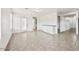 Expansive living space featuring tile flooring, direct backyard access, and breakfast bar at 11836 W Rosewood Dr, El Mirage, AZ 85335