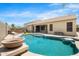 Relaxing backyard view of the swimming pool and patio area ideal for enjoying the warm weather at 11958 W Villa Chula Ln, Sun City, AZ 85373