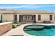 The backyard has a sparkling swimming pool, covered patio, and well-maintained landscaping at 11958 W Villa Chula Ln, Sun City, AZ 85373