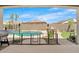 Charming backyard view of the fenced pool, barbecue and patio area with palms for a refreshing outdoor experience at 11958 W Villa Chula Ln, Sun City, AZ 85373