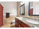A bathroom with double granite vanity, decorative tile, and a toilet in a separate area at 11958 W Villa Chula Ln, Sun City, AZ 85373