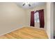 Neutral bedroom with wood floors, red curtained window, and spacious layout at 11958 W Villa Chula Ln, Sun City, AZ 85373