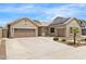 A home with ample parking on a large driveway and a two car garage, complimented by desert landscaping at 11958 W Villa Chula Ln, Sun City, AZ 85373