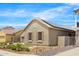A well-maintained exterior showcasing modern solar panels, a low-maintenance yard, and neutral color palette at 11958 W Villa Chula Ln, Sun City, AZ 85373