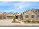 Charming single-story home featuring a well-manicured lawn, desert landscaping, and a spacious two-car garage at 11958 W Villa Chula Ln, Sun City, AZ 85373