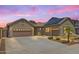 Charming single-story home featuring a three-car garage, landscaped yard, and solar panels at 11958 W Villa Chula Ln, Sun City, AZ 85373